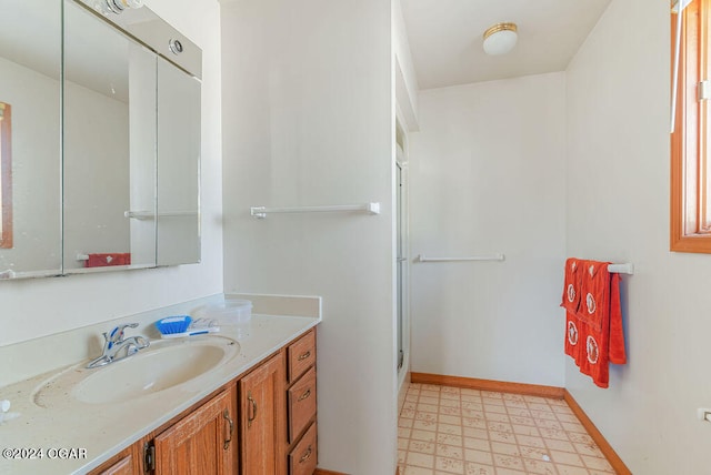 bathroom featuring tile floors and vanity with extensive cabinet space