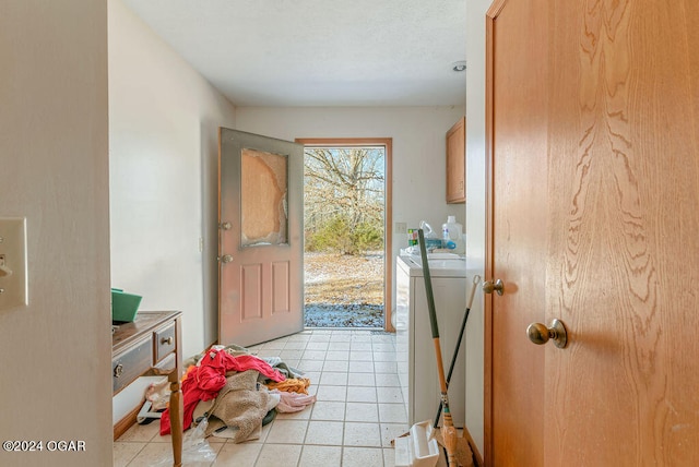 tiled foyer with separate washer and dryer