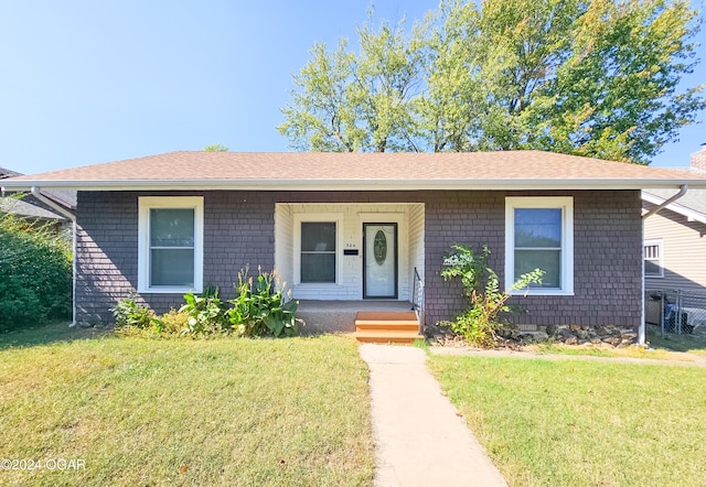 view of front of home featuring covered porch and a front yard