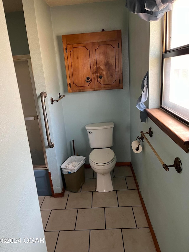 bathroom featuring tile flooring and toilet