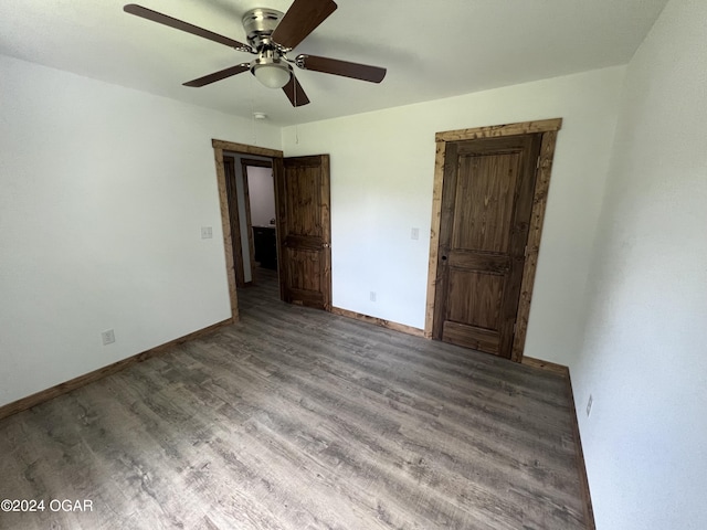 unfurnished bedroom featuring hardwood / wood-style flooring and ceiling fan