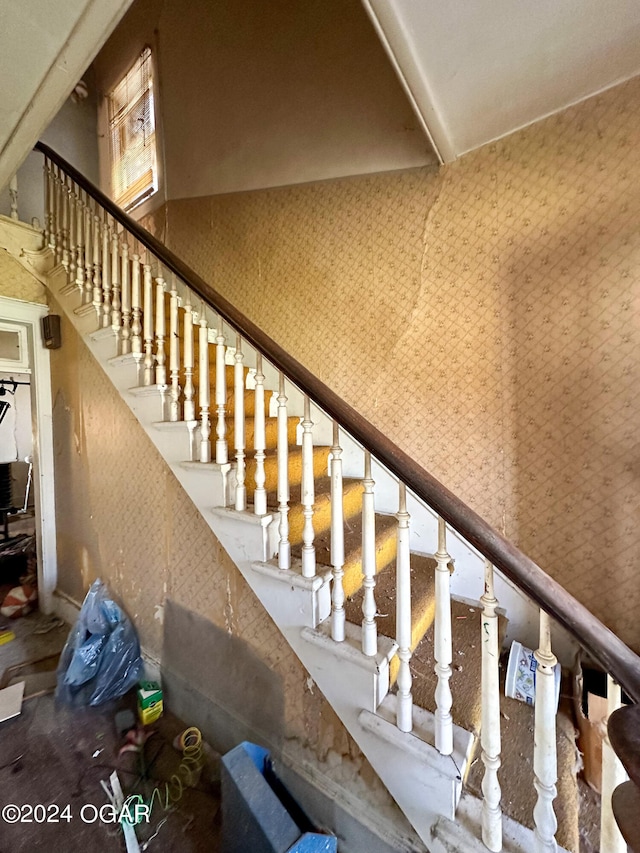 stairs featuring a towering ceiling