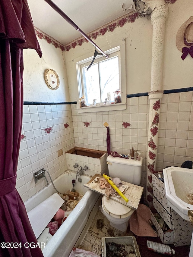 full bathroom with sink, shower / bath combo, toilet, and tile walls