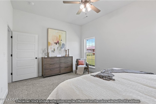 carpeted bedroom with ceiling fan and lofted ceiling