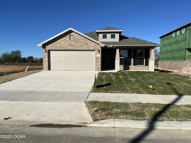 view of front of property with a front yard and a garage