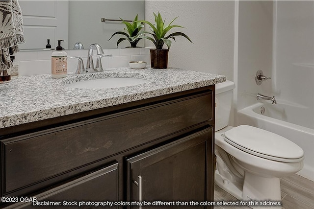 full bathroom featuring hardwood / wood-style flooring, toilet, vanity, and shower / bathtub combination