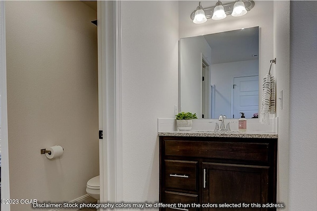 bathroom with toilet and oversized vanity