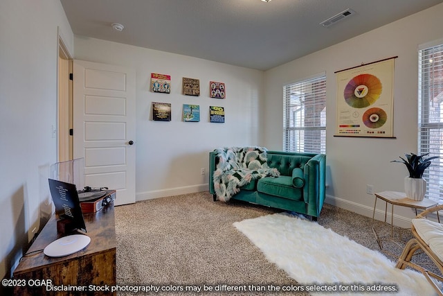 sitting room featuring light colored carpet