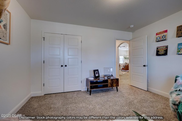 bedroom with light colored carpet and a closet