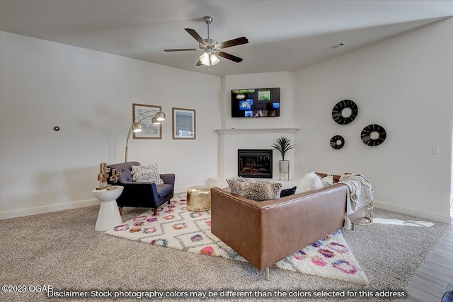 living room featuring ceiling fan, light carpet, and a brick fireplace