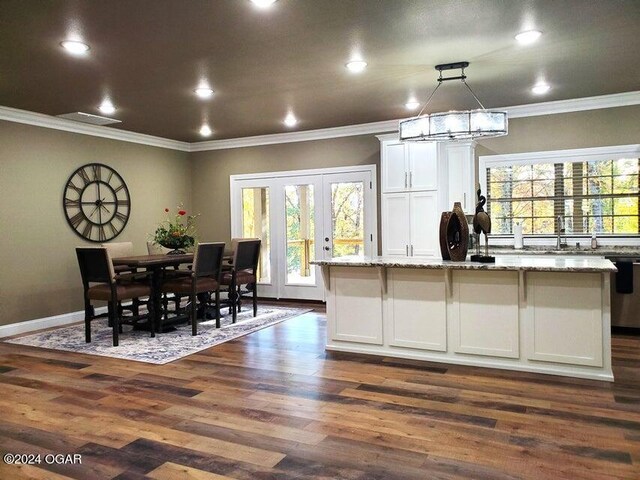21942 Mill Creek Cir, Shell Knob, MO 65747 - kitchen with dark hardwood / wood-style flooring, hanging light fixtures, white cabinetry, and light stone countertops
