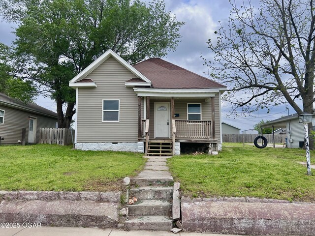 2311 Bird Ave, Joplin, MO 64804 - bungalow-style house featuring fence, covered porch, and a front yard