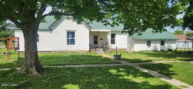 view of front facade featuring a front yard and metal roof