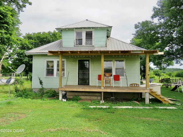 rear view of property with a yard