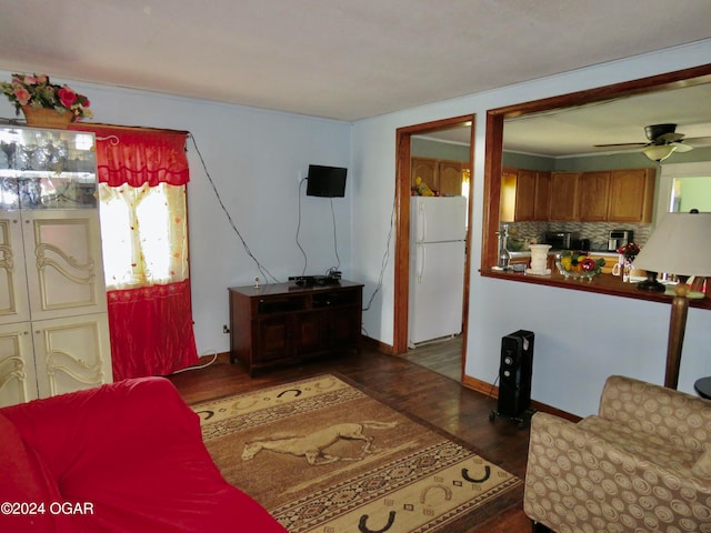 living room featuring dark wood-type flooring and ceiling fan