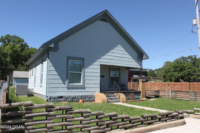 bungalow-style home featuring a front yard