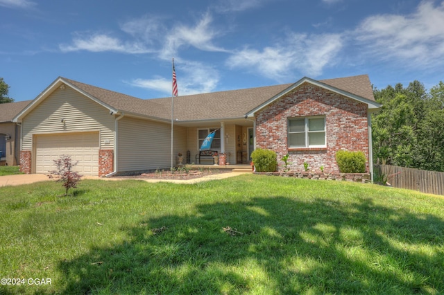 ranch-style home with a front yard, a garage, and covered porch