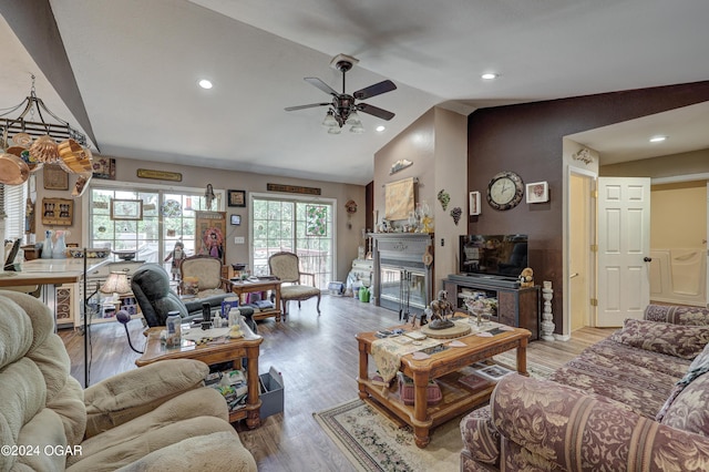 living room with high vaulted ceiling, ceiling fan, and wood-type flooring