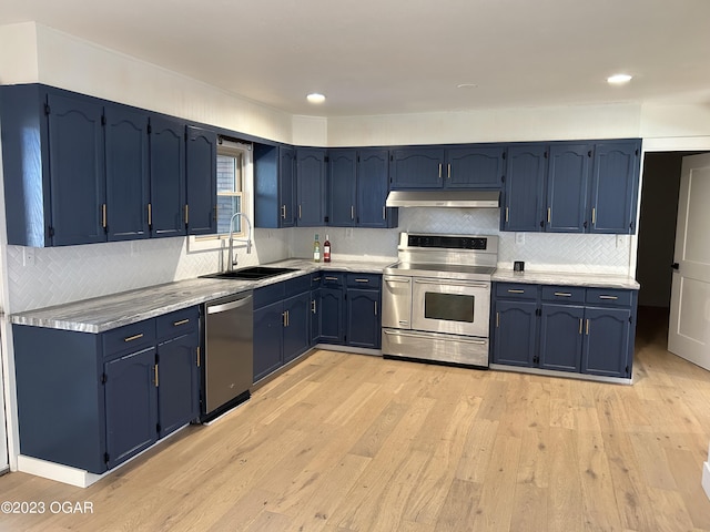 kitchen with blue cabinetry, light wood-type flooring, sink, and appliances with stainless steel finishes