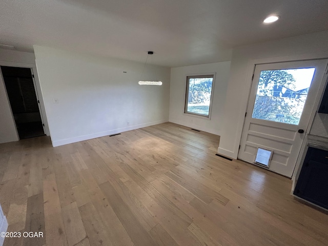 unfurnished living room with light wood-type flooring