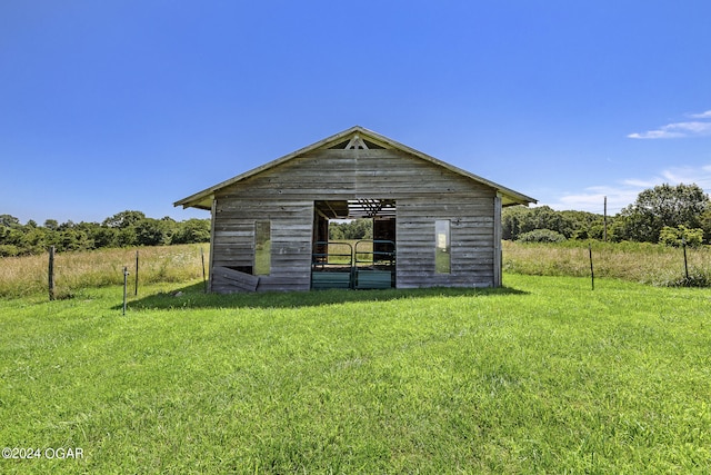 view of outdoor structure featuring a lawn