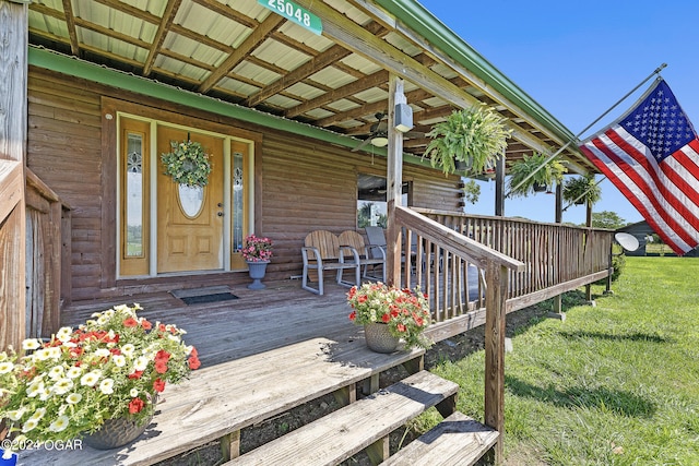 deck with ceiling fan and a lawn