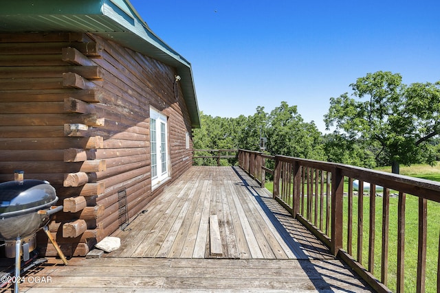 wooden deck with a yard and grilling area