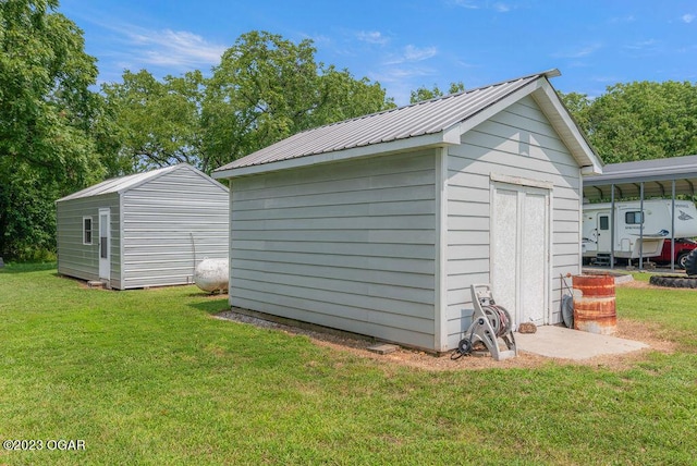 view of outbuilding featuring a yard