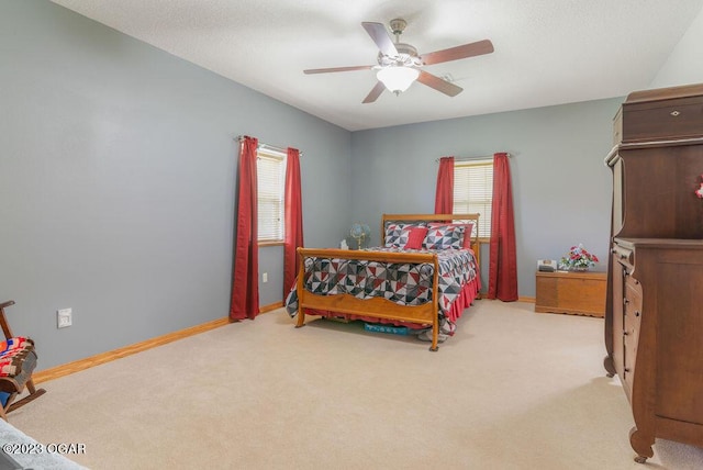 bedroom with ceiling fan and light carpet