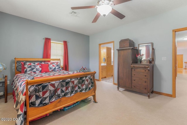 carpeted bedroom with ceiling fan and ensuite bathroom