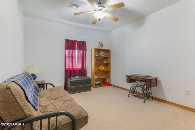 sitting room featuring ceiling fan and light colored carpet