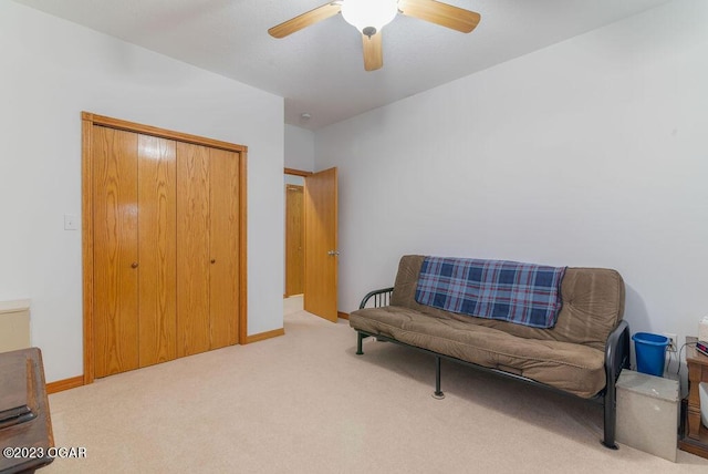 sitting room featuring ceiling fan and light colored carpet