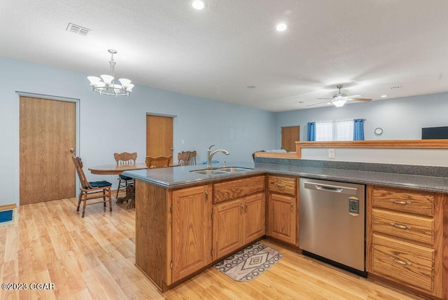 kitchen featuring decorative light fixtures, sink, kitchen peninsula, stainless steel dishwasher, and light hardwood / wood-style flooring