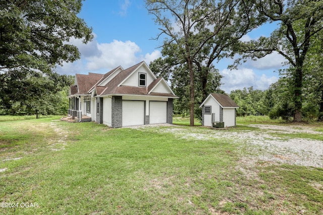 view of side of home featuring a lawn, a storage shed, and central air condition unit