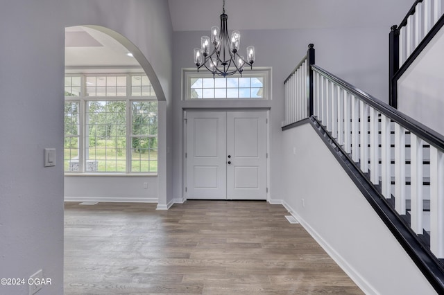 entrance foyer with wood-type flooring and an inviting chandelier