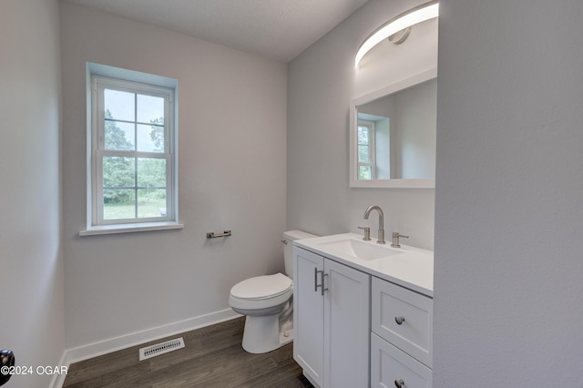 bathroom featuring toilet, hardwood / wood-style floors, and vanity