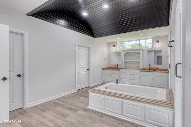 bathroom featuring lofted ceiling, vanity, hardwood / wood-style flooring, wood ceiling, and shower with separate bathtub