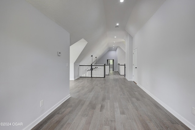 bonus room with light hardwood / wood-style floors and lofted ceiling