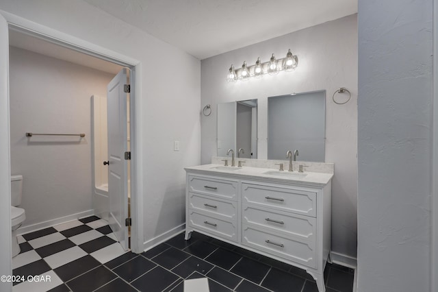 bathroom featuring a tub, toilet, and vanity