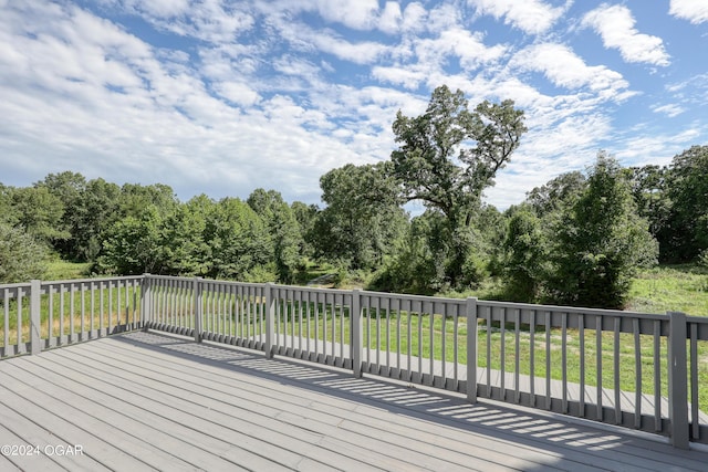 wooden deck featuring a lawn