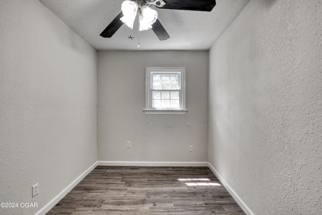 empty room with hardwood / wood-style floors, ceiling fan, and a textured ceiling