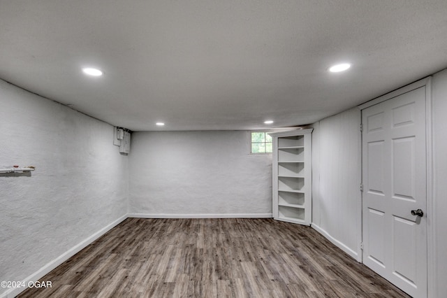 basement with dark hardwood / wood-style flooring