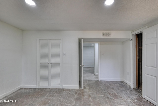 unfurnished bedroom with a textured ceiling