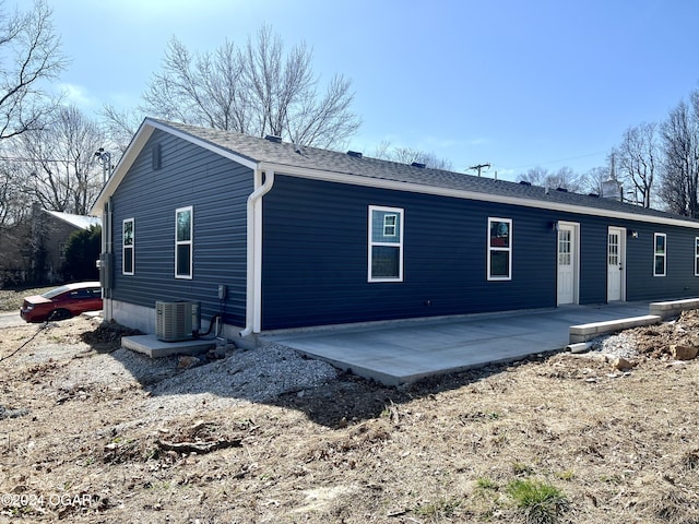 back of house with central air condition unit and a patio area