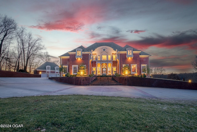 view of front of house featuring a garage and a yard