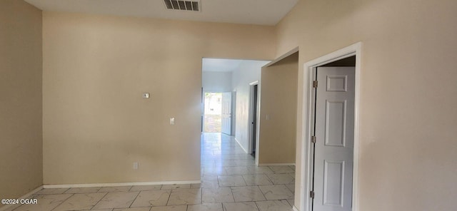 corridor featuring light tile patterned floors