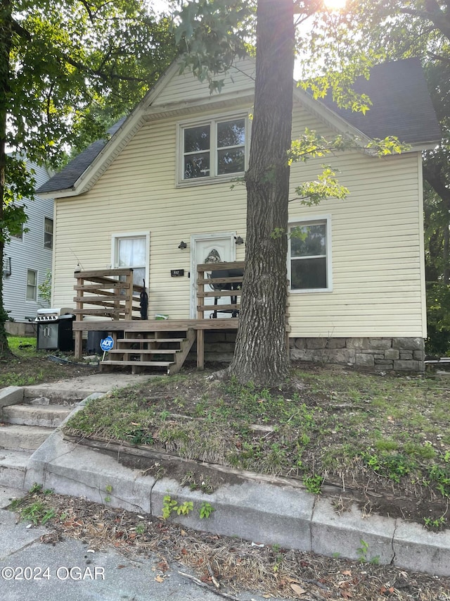 rear view of house featuring a deck