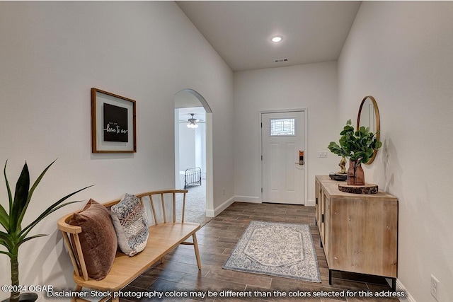 foyer entrance with dark wood-type flooring and ceiling fan