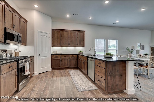 2323 N Miller Ave, Joplin, MO 64801 - kitchen featuring light wood finished floors, stainless steel appliances, visible vents, and a sink
