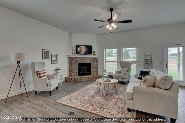 living room with ceiling fan, a fireplace, and light hardwood / wood-style flooring